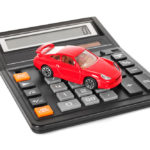 Red car on black calculator