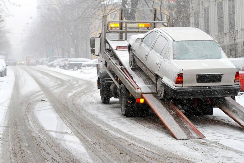 Towing a car on snowy street