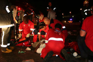 Accident at night, helpers rescue the victims. 